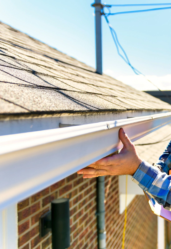 man inspecting house roof